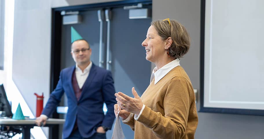 Faculty member teaching graduate students in a Walton College classroom