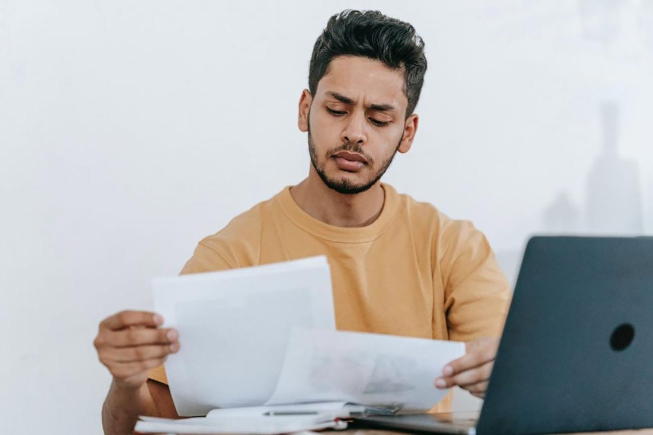 Photo of a student examining a printed case study