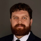 Headshot of Finn Mckinley with suit and tie on