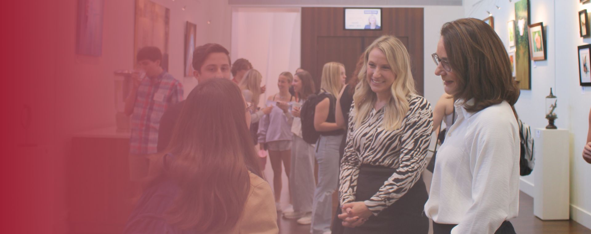 BILI founder, Cindy Moehring, and Michele Edwards talking with a Walton College student
