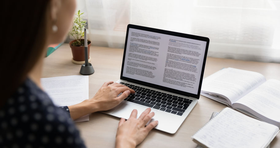 Woman reading document on computer