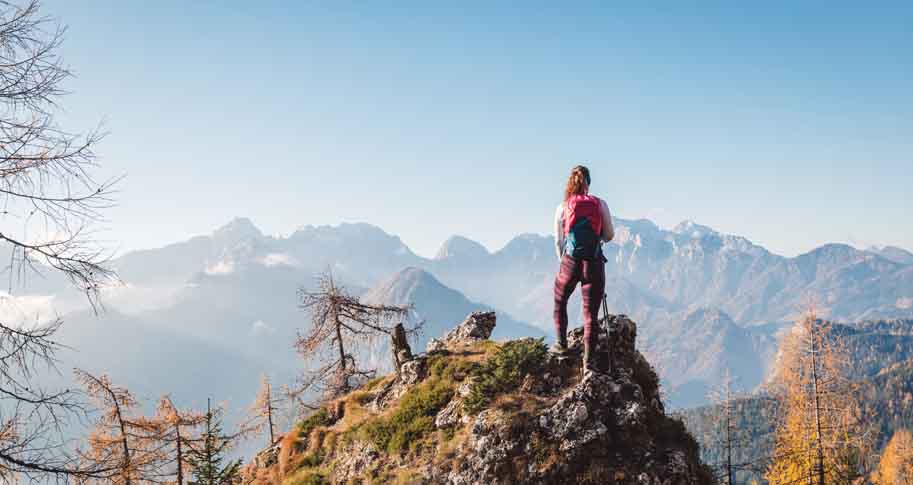 Women standing alone at the top of a mountain