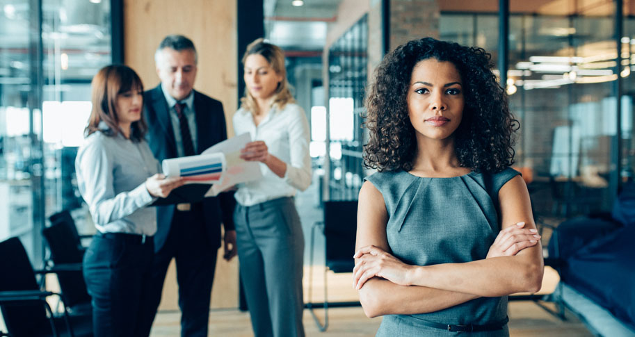 Woman looking serious with her team behind her