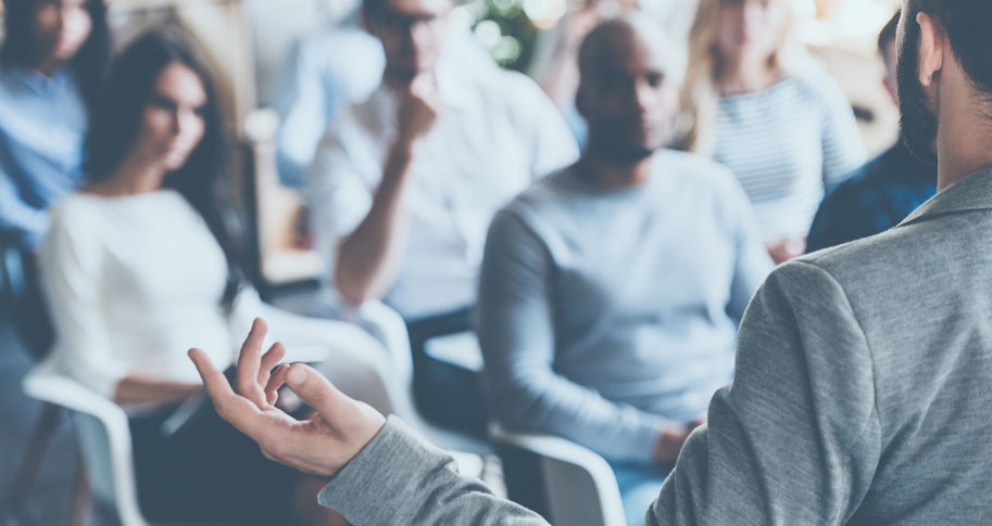 Man giving lecture to group of students