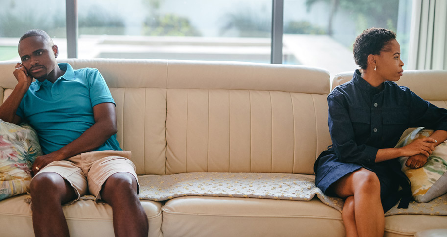 A couple amid an argument while sitting on a couch. Article: 