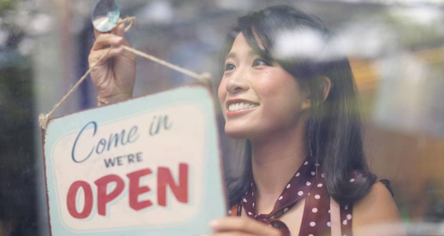 woman with open sign for store