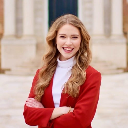 Grace Crain (Walton MBA '23) poses in front of Old Main as she prepares to take on her full-time role with Deloitte in Austin post-graduation this Spring. 