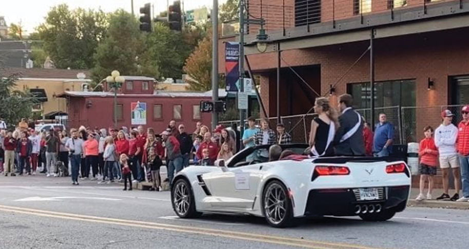 Grace rides in the royal car during the homecoming parade.