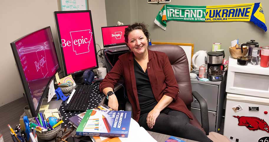 Katie Terrell sitting at her desk in her office