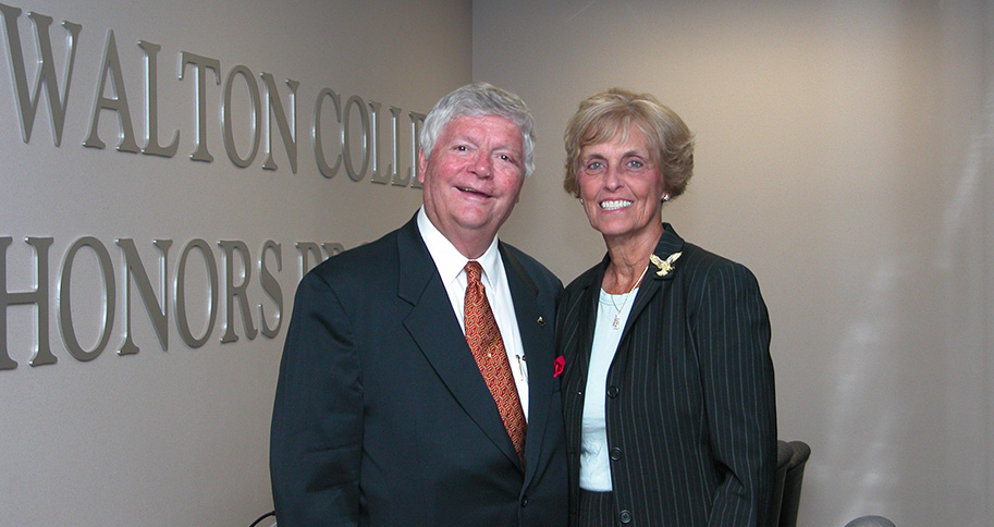 Bill and LeAnn Underwood stand in the Honors College lounge at Walton College.