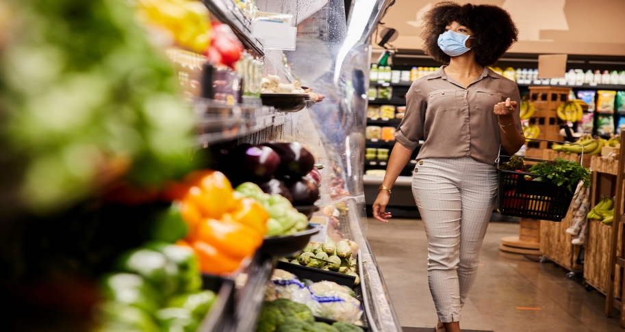 Woman wearing a mask shops for groceries