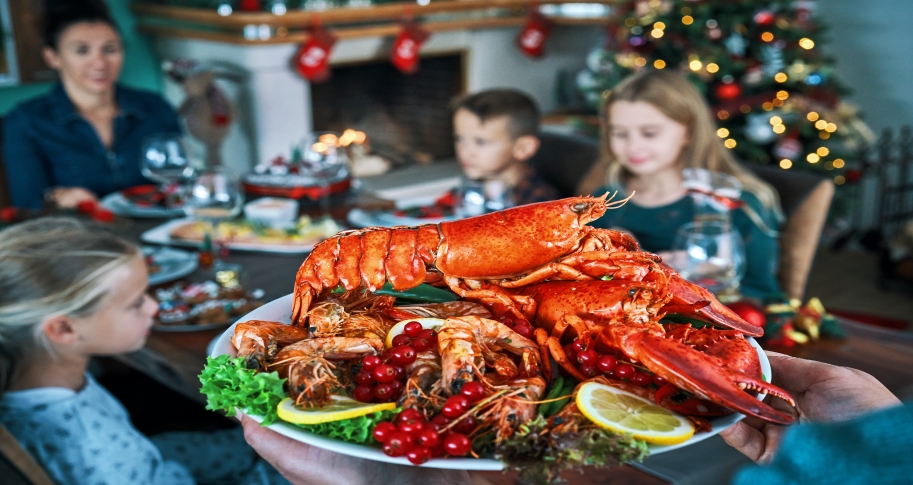 Seafood platter being brought to a family's dinner table on Christmas