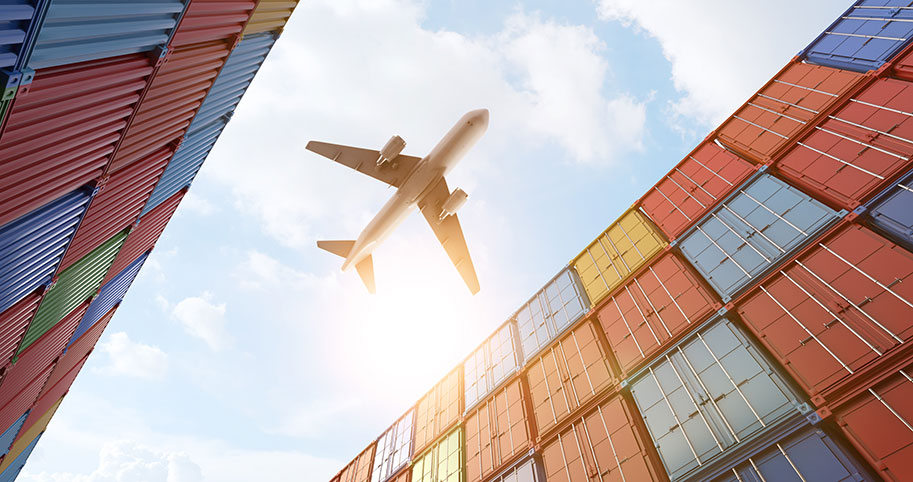 airliner above freight containers