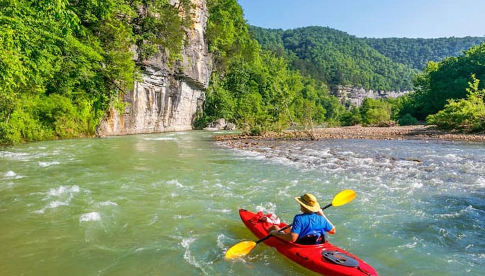 a man paddling a canoe instead of attending class